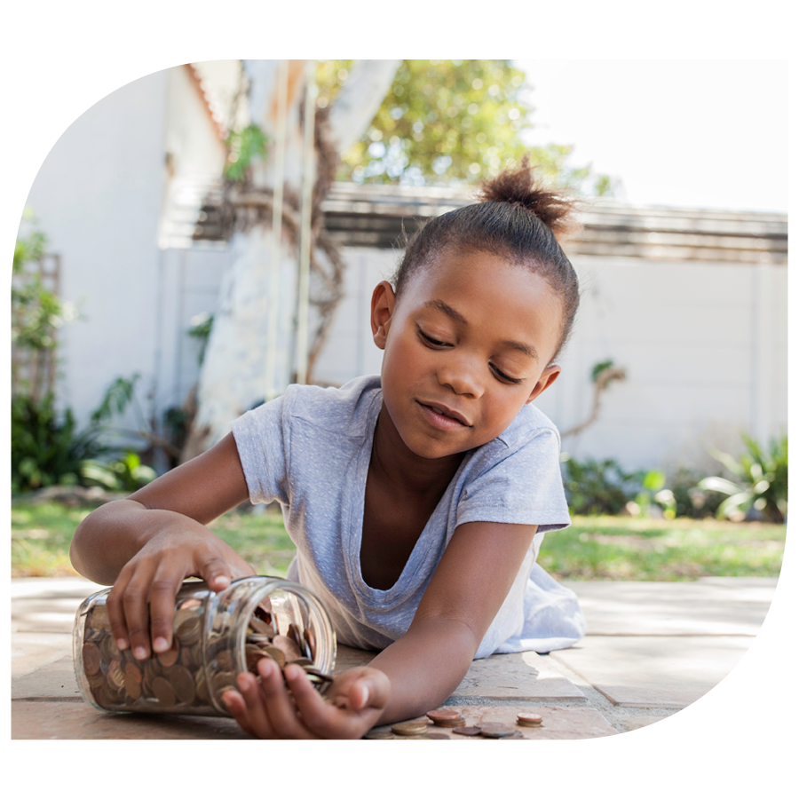 young girl outside pouring coings out of large jar